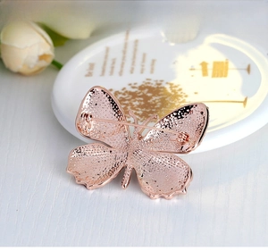 Detail view of the rose gold butterfly brooch back showing sturdy safety pin and clasp