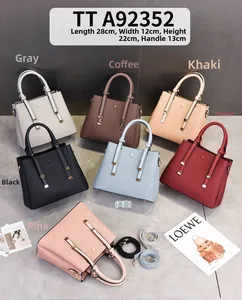Detail view of stylish synthetic leather handbags showing dimensions 28x12x22cm in 7 colors