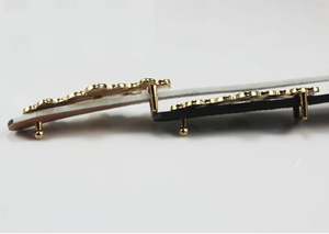 Close-up of gold flower buckle hardware for skinny PU belts in black and white colors