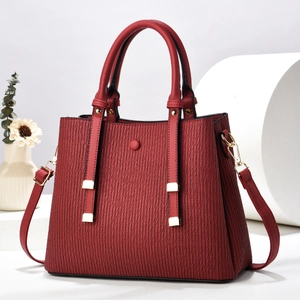 Elegant red textured PU leather handbag for women with gold hardware and top handles