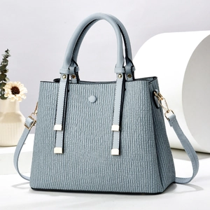 Fashionable light blue pleated trapezoid handbag with dual handles and gold hardware