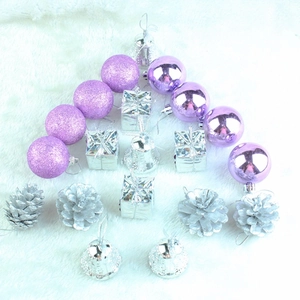 Christmas tree decoration set with purple glitter balls and silver ornaments on white rug