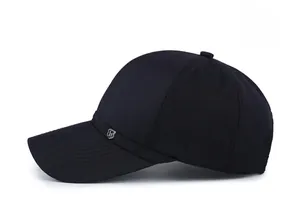 Side view of a classic black cotton baseball cap with a small metal shield logo detail