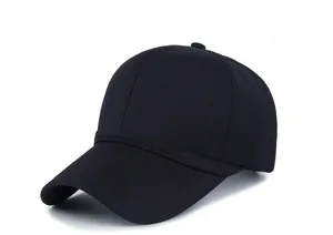 Detail view of a navy blue cotton baseball cap with a decorative metal shield badge