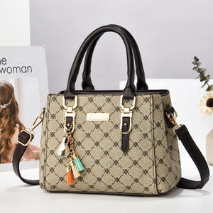 Chic vintage monogram tote bag with gold hardware and colorful tassel charm decoration