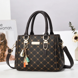 Vintage brown crossbody bag with XEX monogram pattern and colorful tassel charm