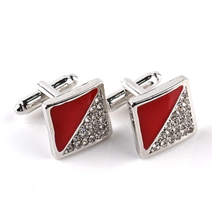 Detail of square cufflinks with red enamel and white rhinestones on silver metal base