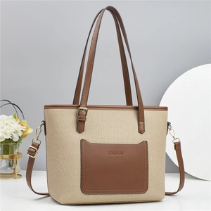 Canvas and brown leather bucket bag with top handles and adjustable shoulder strap