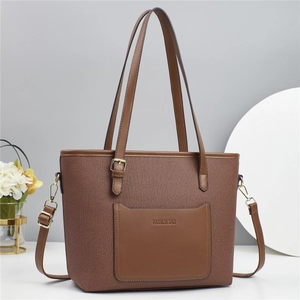 Brown woven tote bag with smooth leather trim and adjustable shoulder strap for women