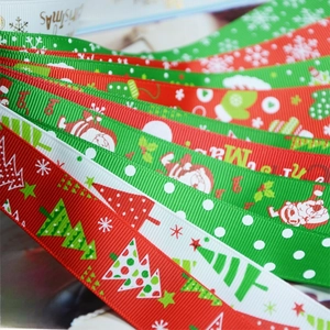 Close-up of assorted Christmas ribbons with Santa, tree and snowflake patterns