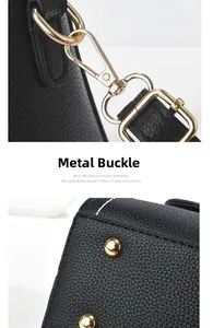 Detail of premium black lychee pattern leather bag with gold metal clasp and bottom studs