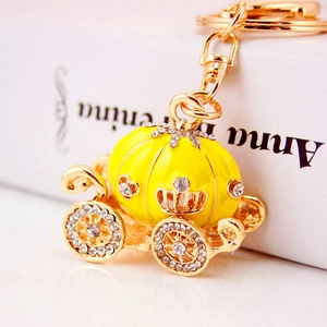Exquisite golden pumpkin carriage keychain with yellow enamel and sparkling white crystals