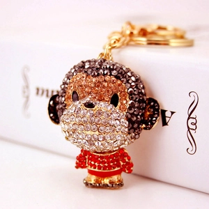 Cute cartoon monkey keychain with rhinestones and gold metal ring on gift box