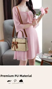 Detail of the soft texture of the PU leather and heart-shaped metal buckle on the lady bag