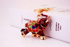 Macro detail of red enamel elephant keychain with vibrant multicolor crystal rhinestones