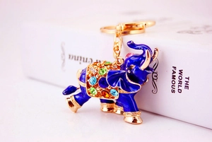 Detail of blue enamel elephant keychain with colorful rhinestones and gold metal finish