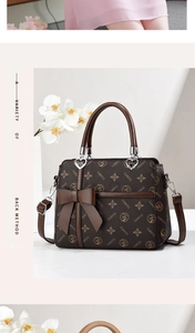 Detail of crossbody bag with brown monogram pattern and large decorative bow accent