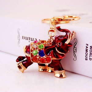 Sparkling crystal elephant keychain with red enamel and gold-plated details for bags