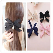 Elegant satin bow hair clip featuring a teardrop pearl center in four different colors