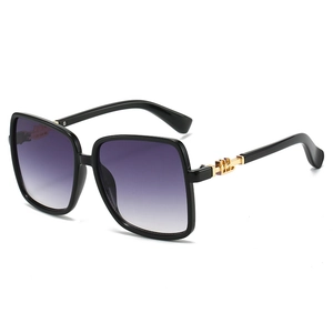 Fashionable large square black sunglasses with purple gradient lenses and gold metal temples