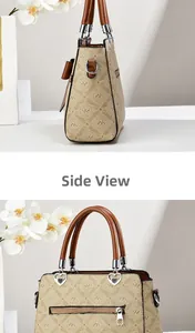 Detail view of apricot handbag side and front with heart-shaped metal connectors