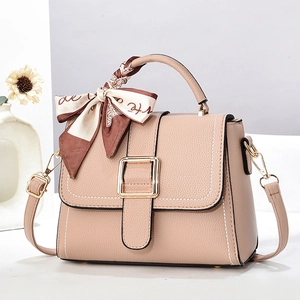 Chic beige lychee leather tote with gold buckle and silk scarf on the handle