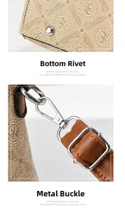 Detailed view of beige handbag showing protective metal studs and swivel lobster clasps
