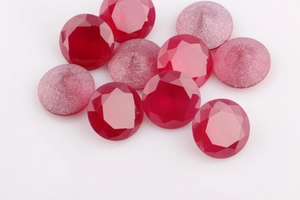 Macro shot of dark red faceted ruby loose beads with polished and frosted textures