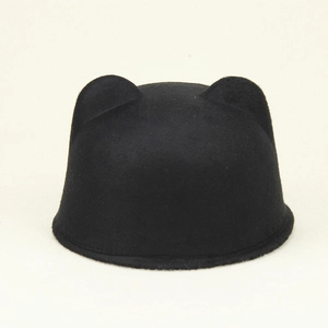 Detail of black felt equestrian hat featuring cute cat ears and thick wool texture