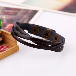 Detail of multi-layer braided black leather bracelet with bronze metal snap buttons