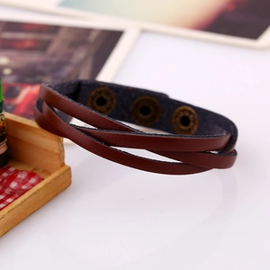 Detail view of multilayer brown leather bracelet with vintage bronze snap buttons