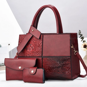 Three-piece burgundy faux crocodile tote set with handbag, clutch, and card holder