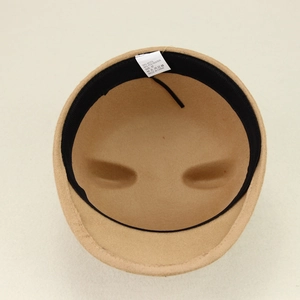Detail of wool blend hat lining showing black sweatband and size 57 care label