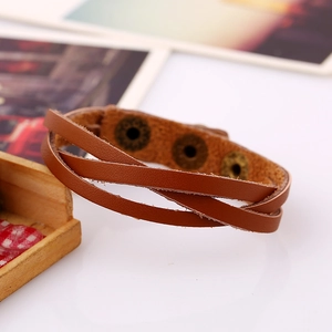 Close-up of brown multi-layer leather bracelet with three vintage brass snap fasteners