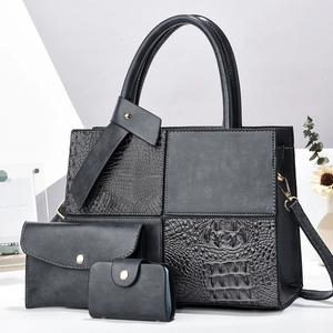 Three-piece black tote bag set with crocodile pattern拼接 details and gold hardware