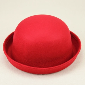 Detailed view of the red wool felt bowler hat featuring a classic curved crown and rolled brim