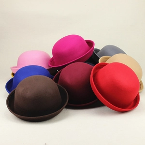 Stack of vintage felt bowler hats showing various colors like burgundy, pink and blue