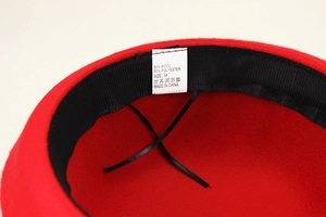 Detail of red wool felt hat interior with 50% wool blend label and sweatband