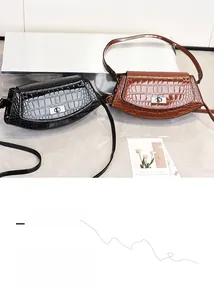 Close-up of black and brown vintage crocodile texture handbags with silver metal locks
