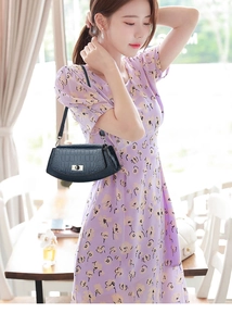 Detail of elegant dark blue crocodile embossed shoulder bag with silver metallic turn lock