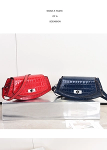 Detail of crocodile embossed leather shoulder bags with silver twist-lock and slim straps