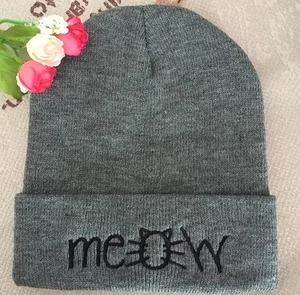 Detailed knit texture of grey beanie featuring Meow cat face embroidery and ribbed cuff