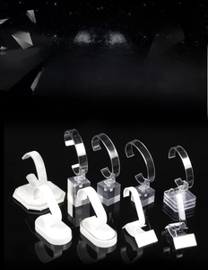 Close-up of C-type watch display stands with acrylic bases and velvet textures