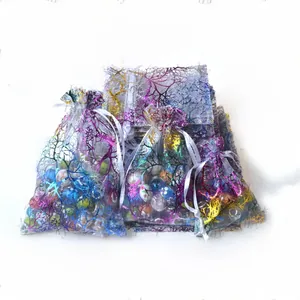 Detailed view of sheer organza drawstring gift bags with colorful coral pattern prints