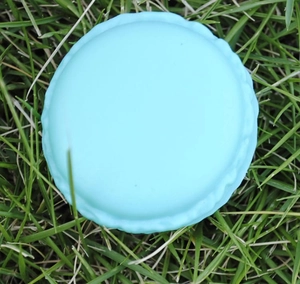 Light blue macaron jewelry box for rings on green grass background, top view detail