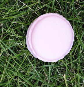 Pink macaron mini jewelry box for rings on green grass background, detailed storage view