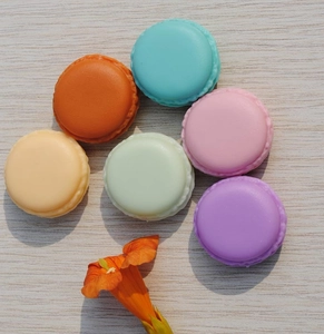 Detailed top view of six macaron shaped mini jewelry organizers in various pastel colors