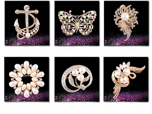 Detailed catalog showing assorted crystal flower and anchor pearl brooches in various sizes
