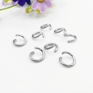 Macro detail of silver stainless steel spiral jump rings for jewelry making