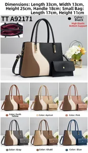 Detail of multi-color leather tote bag showing wave stitching and golden metal buckles